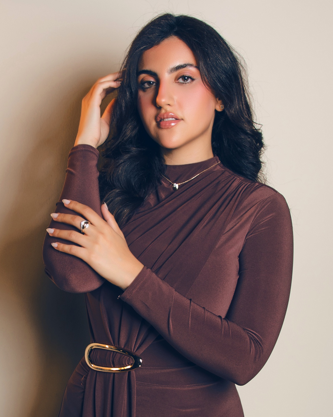 Zorae social portrait of model in a draped brown dress wearing fine jewellery