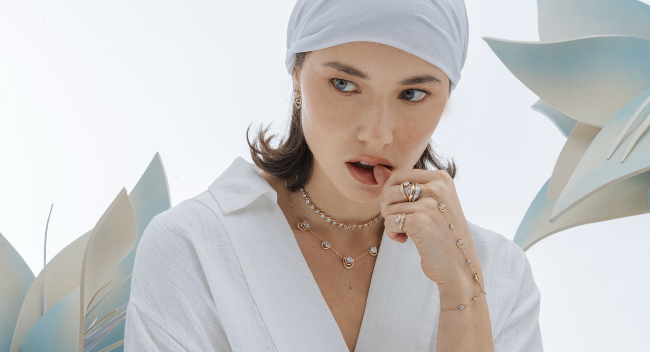 Model wearing ZORÁE fine jewellery with paper flowers